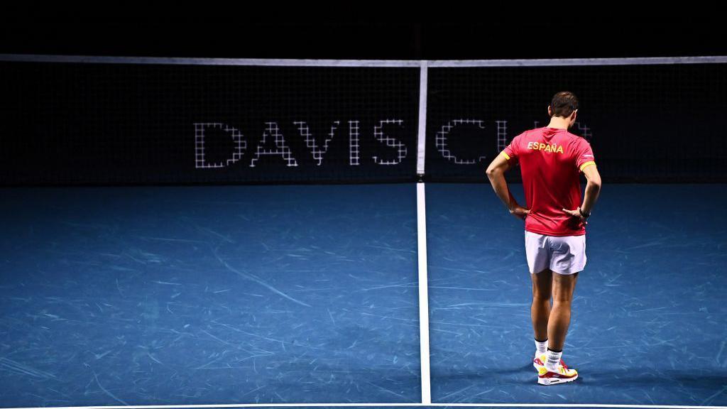 Rafael Nadal stands on the court after retiring from tennis