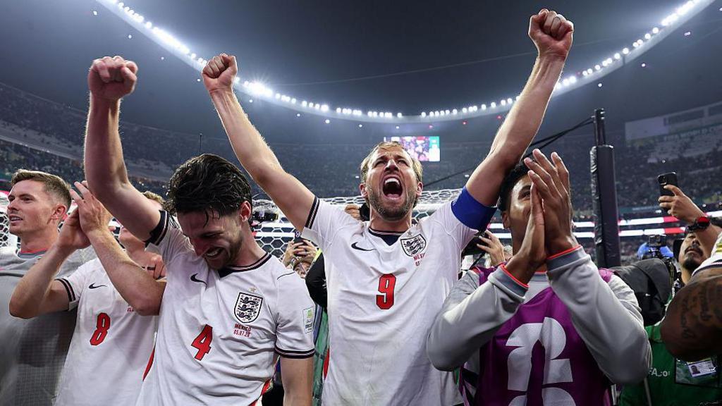 England players celebrate their win against Mexico