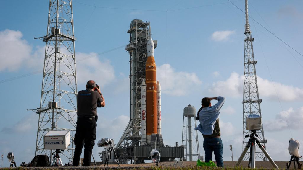 People photograph NASA's next-generation moon rocket, the Space Launch System (SLS) rocket with the Orion crew capsule, on Pad 39B ahead of the Artemis II mission launch at the Kennedy Space Center in Cape Canaveral, Florida