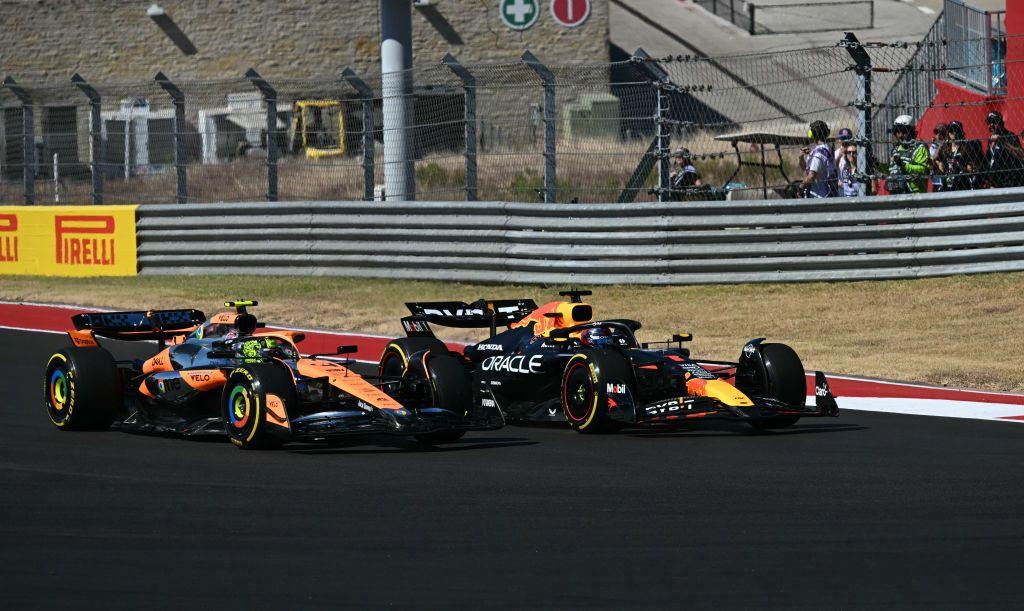 Lando Norris with Max Verstappen alongside him at the first corner