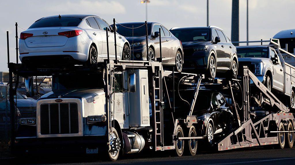 Vehicles are parked on car carrier trailers ready for distribution at a vehicle processing lot at the National City Marine Terminal, a major port for vehicle imports and exports, particularly for new foreign cars entering the United States on April 26, 2025 in National City, California