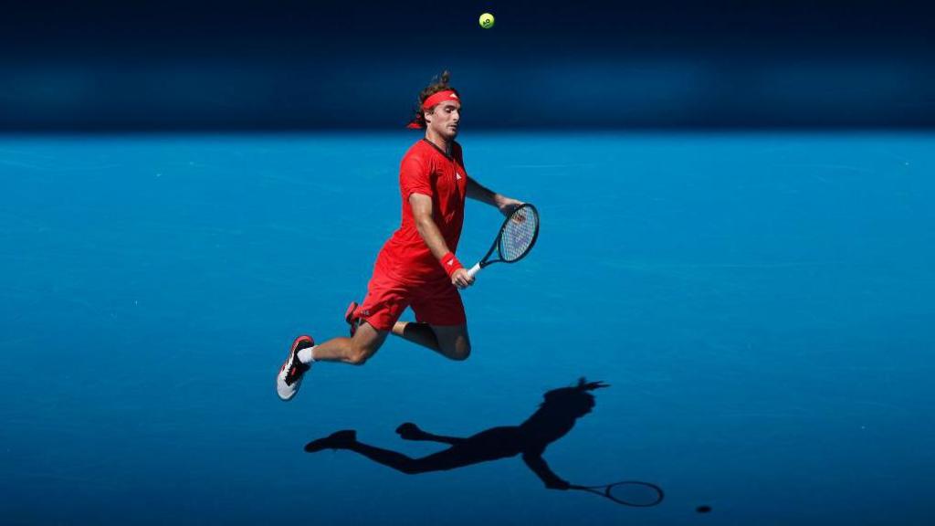 Stefanos Tsitsipas of Greece plays a backhand against Alex Michelsen of the United States in the Men's Singles First Round match during day two of the 2025 Australian Open at Melbourne Park