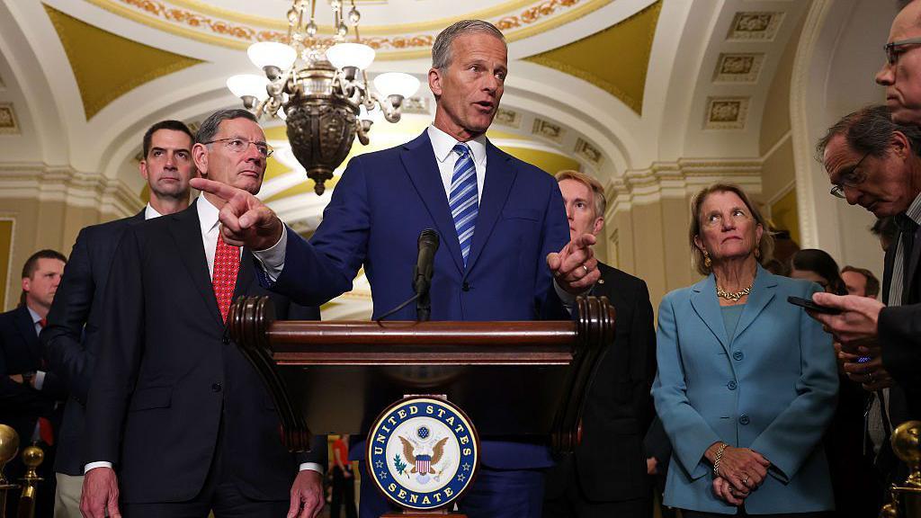 Senate majority leader John Thune speaks speaks at a podium during a news conference