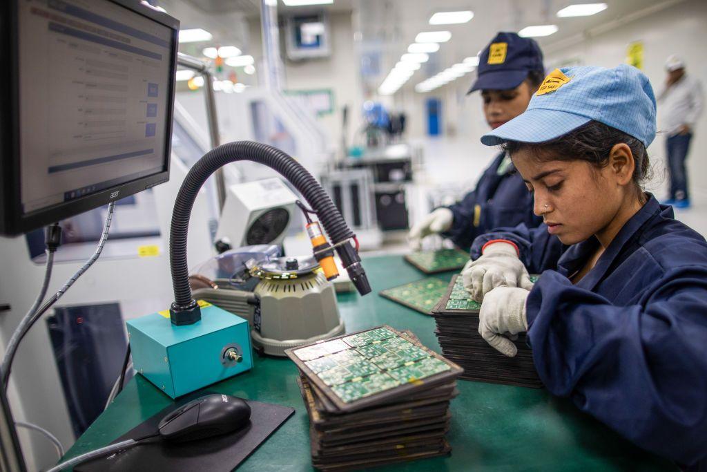 Employees work on the SMT (surface mount technology) shop floor where components are mounted on a PCB (printed circuit board) at Padget Electronics Pvt., a subsidiary of Dixon Technologies Ltd., in Noida, India.