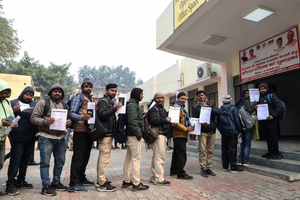 Indian workers align to submit registration forms as they seek employment in Israel during a recruitment drive at the Industrial Training Institute (ITI) in Lucknow, capital of India's Uttar Pradesh state on January 25, 2024.