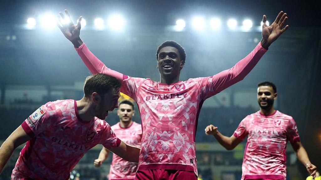 Mohamed Toure celebrates after scoring his third goal against Oxford 
