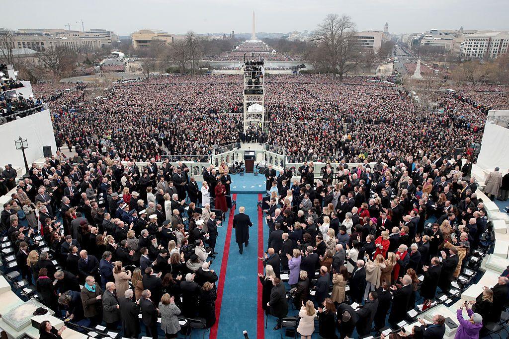 President-elect Donald Trump walks along a blue carpet watched by many thousands as he arrives for his inauguration ceremony in Washington, DC.