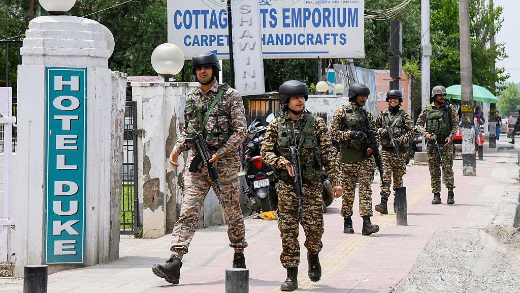 Indian security forces patrol a road near Dal Lake in Srinagar, India, on May 6, 2025. Increased military presence follows the April 22 attack on tourists in Pahalgam, amid rising tensions between India and Pakistan.