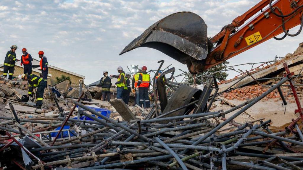  Rescue workers continue their search and rescue efforts at the Neo Victoria apartment building in Victoria Street on May 07, 2024 in George, South Africa