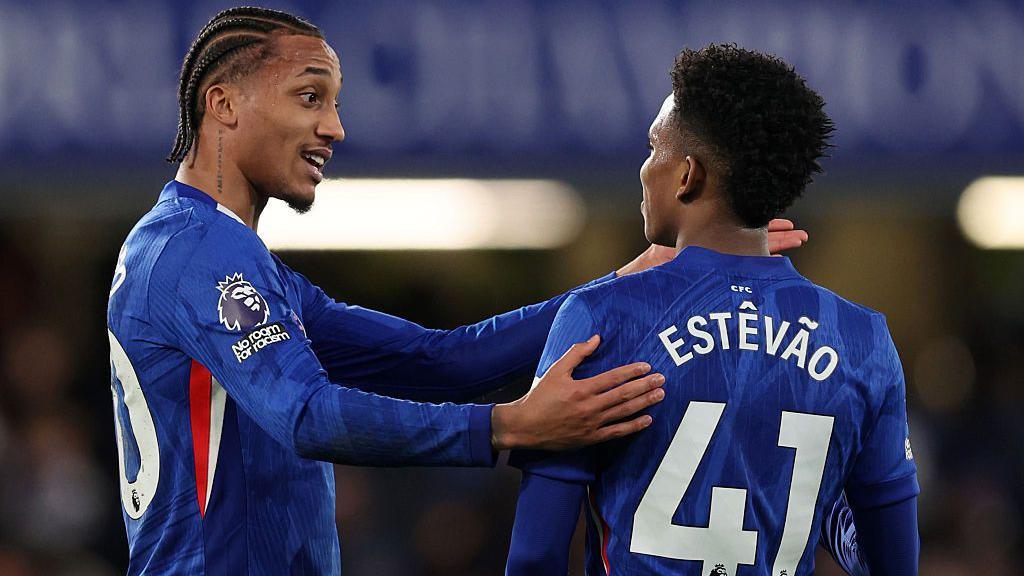 Joao Pedro talks to Estevao during the Premier League match between Chelsea and Arsenal at Stamford Bridge