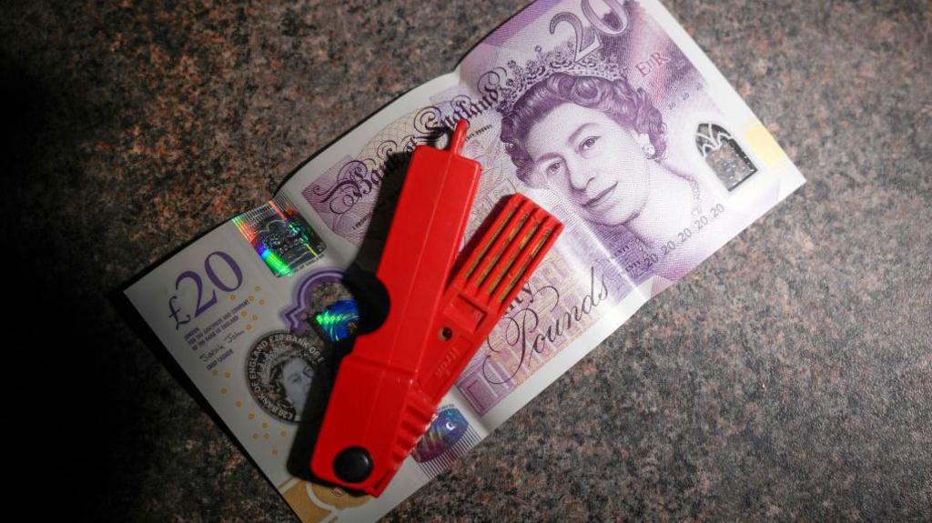 In this photo illustration a prepay electricity key sits in on a 20 GBP note in a rented home