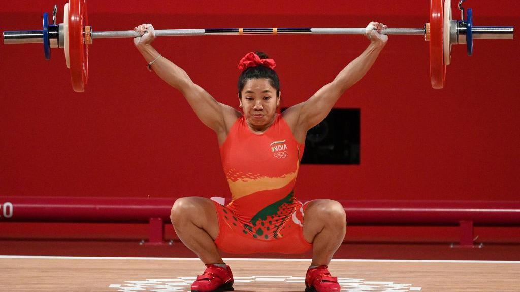 India's Chanu Saikhom Mirabai competes in the women's 49kg weightlifting competition during the Tokyo 2020 Olympic Games at the Tokyo International Forum in Tokyo on July 24, 2021. (Photo by Vincenzo PINTO / AFP) (Photo by VINCENZO PINTO/AFP via Getty Images)