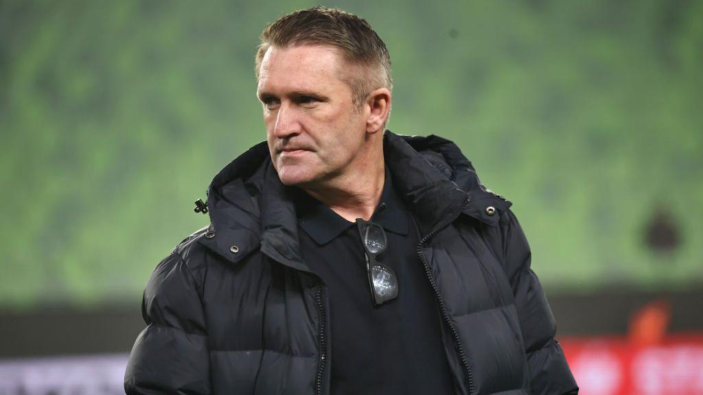 Robbie Keane wearing a black coat