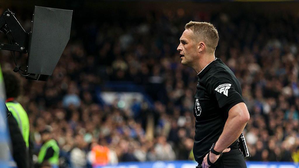 Referee Craig Pawson checks the VAR monitor