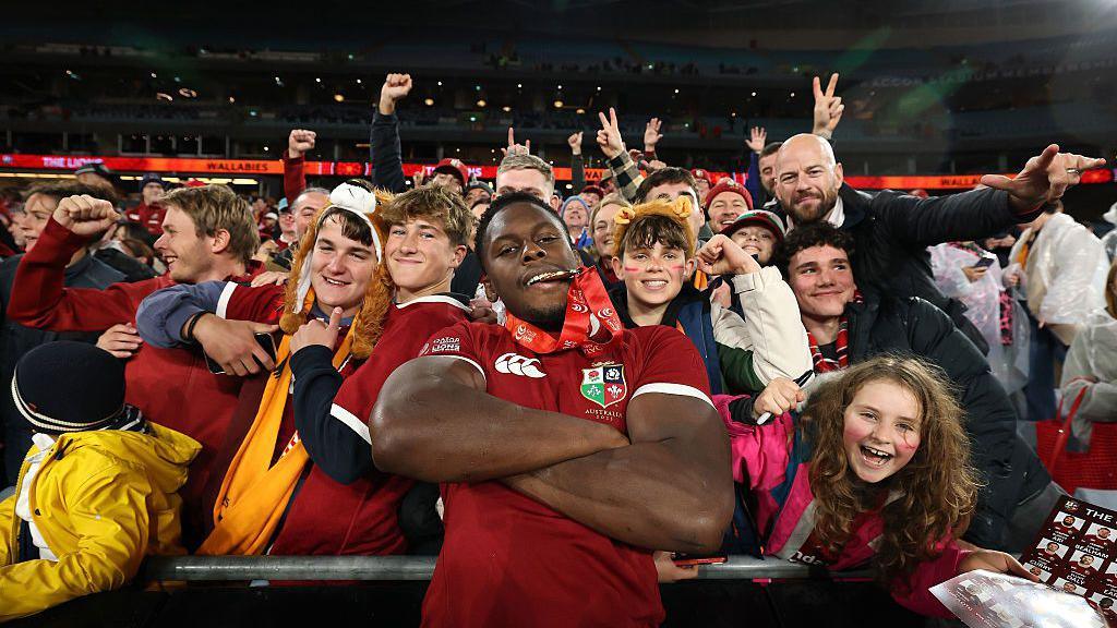 Maro Itoje celebrates with supporters after the British & Irish Lions 2-1 series win in 2025.