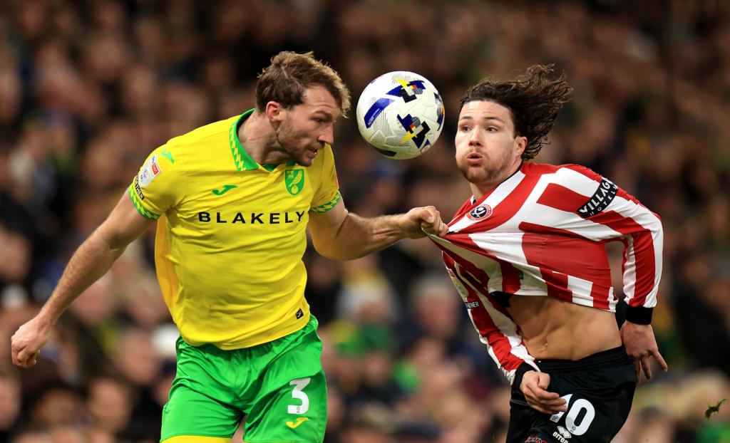 Two football players battling for the ball