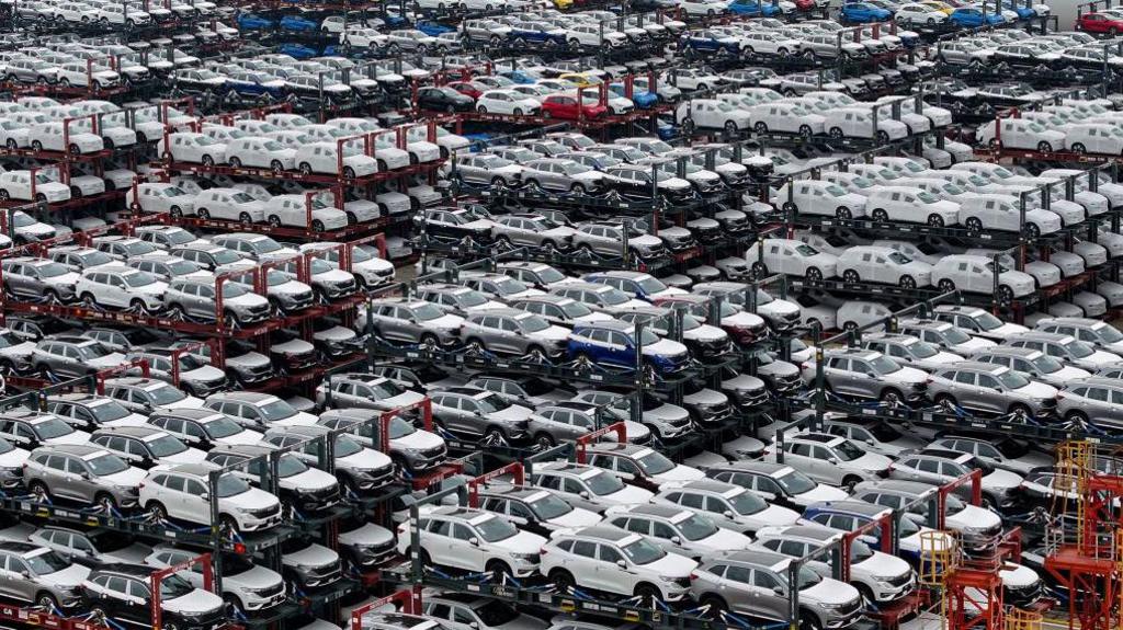 This aerial photograph taken on April 16, 2024 shows electric cars for export stacked at the international container terminal of Taicang Port in Suzhou, in China's eastern Jiangsu Province. 