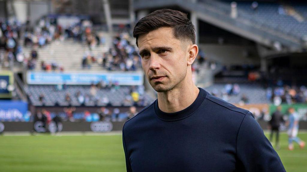 Eric Ramsay ahead of an MLS game wearing a navy blue top
