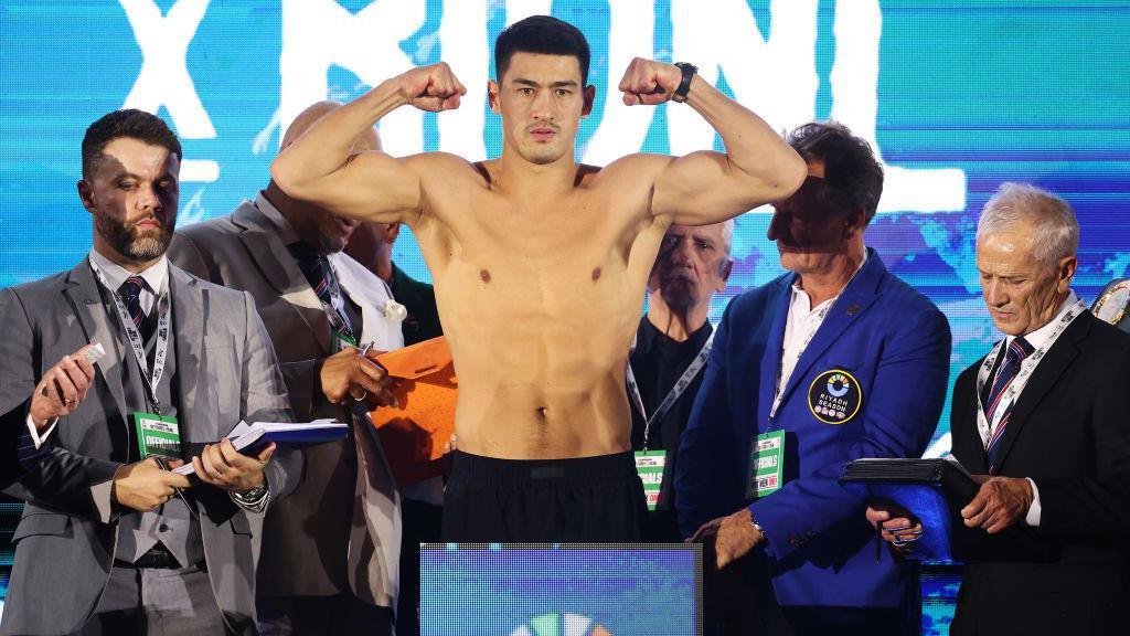 Dmitry Bivol flexes his arm muscles