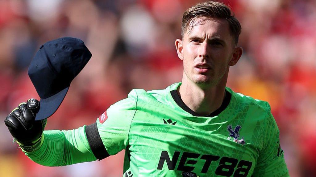 Dean Henderson holding a cup