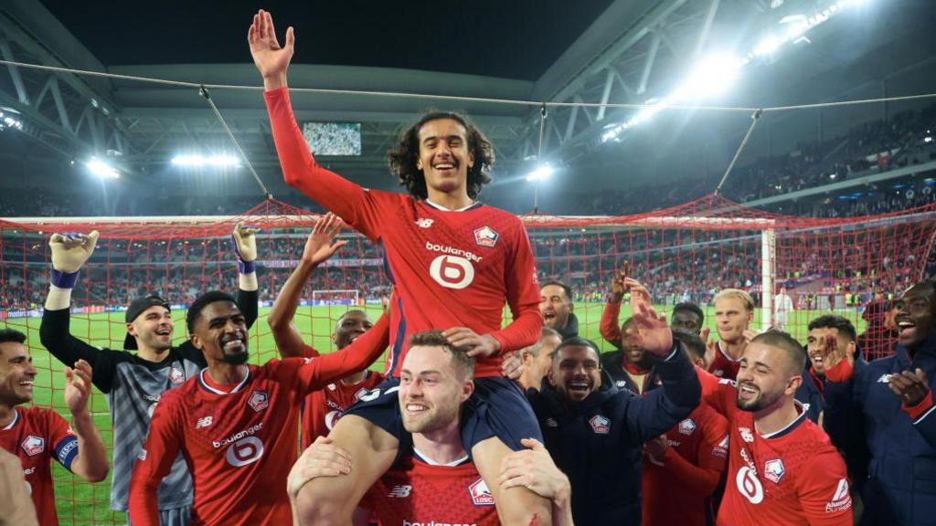 Ayyoub Bouaddi is lifted aloft by one of his teammates after a match