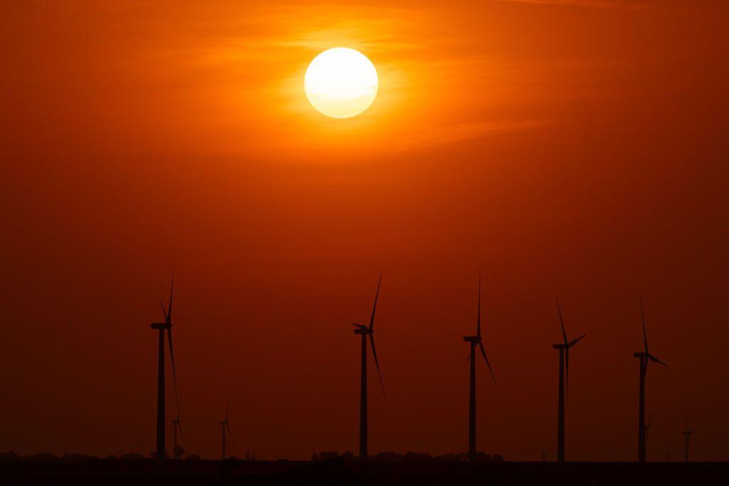 sun sets on a windfarm in Iowa, USA