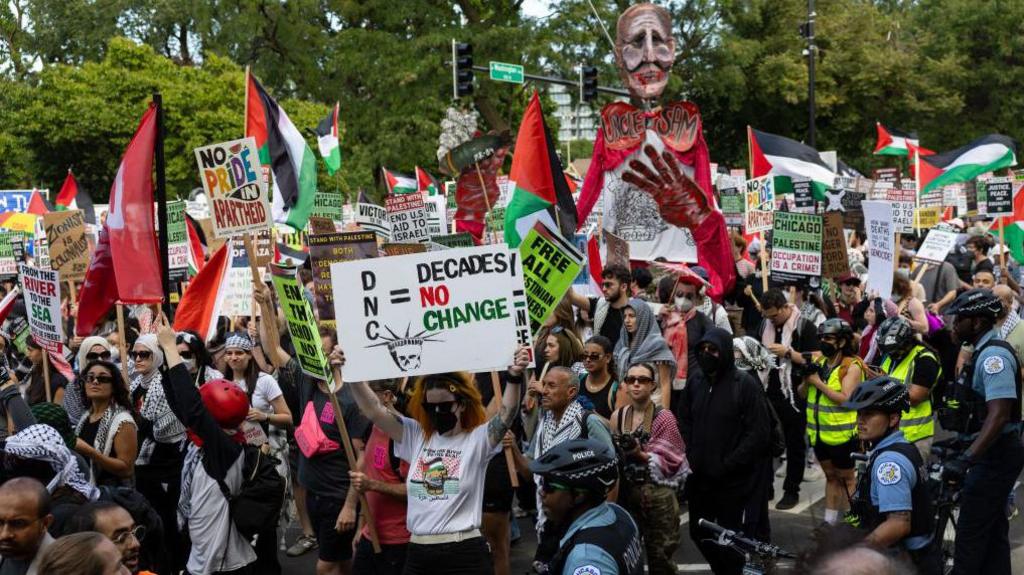 A crowd protests in a city street