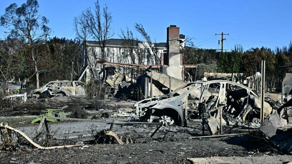  burned-out car and home reduced to rubble by the Palisades Fire is seen in the Pacific Palisades neighbourhood of Los Angeles, California, on January 12, 2025.