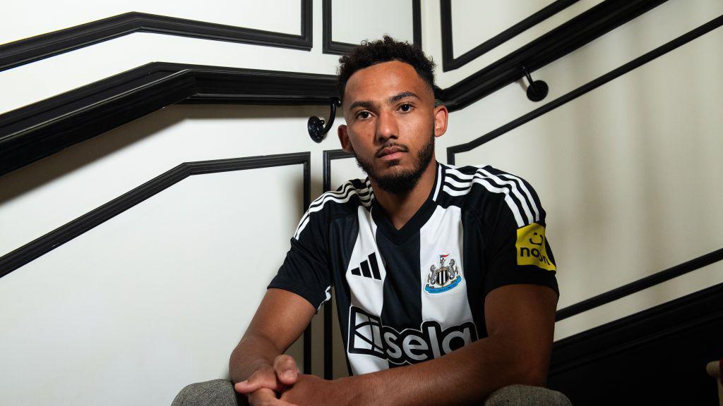 Lloyd Kelly poses for photographs after signing for Newcastle United on June 12, 2024