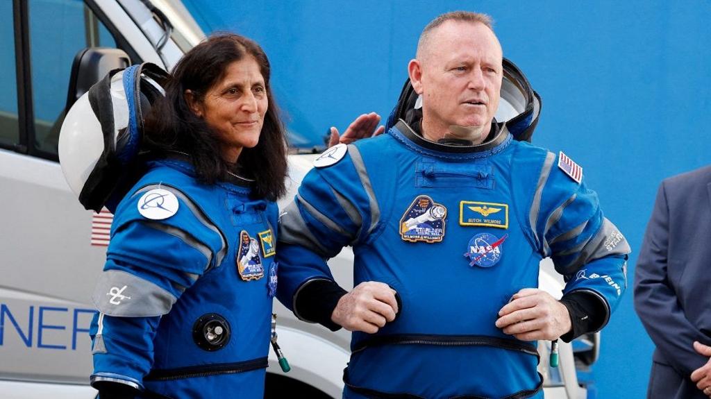 NASA astronauts Butch Wilmore and Suni Williams stand together at NASA's Kennedy Space Center in Florida