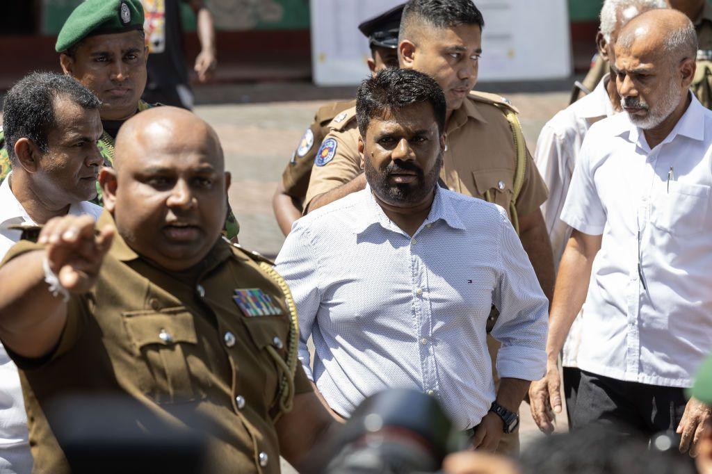 Anura Kumara Dissanayake surrounded by men in uniform