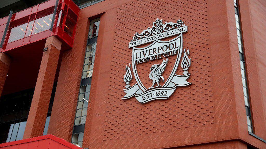 An view of the Liverpool FC club crest on the wall of Anfield stadium, which contains the motto "You'll Never Walk Alone" and the club's founding date of 1892