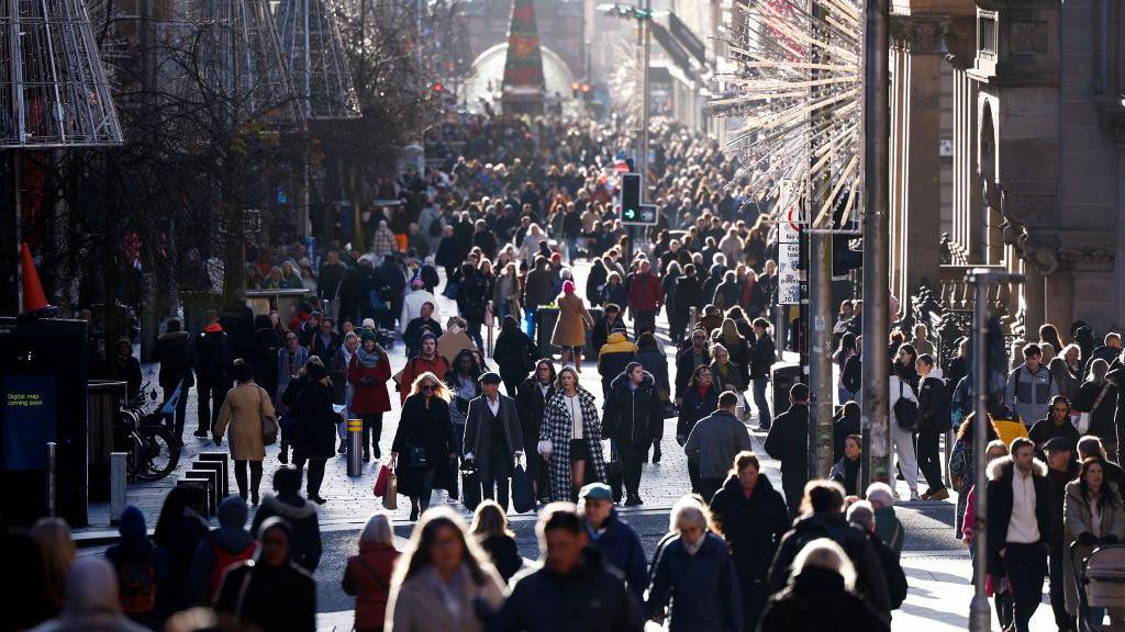 Crowds of shoppers walking up and down Glasgow's Buchanan Street at Christmas time