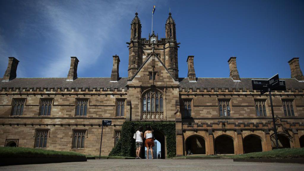 People stand outside a University of Sydney building