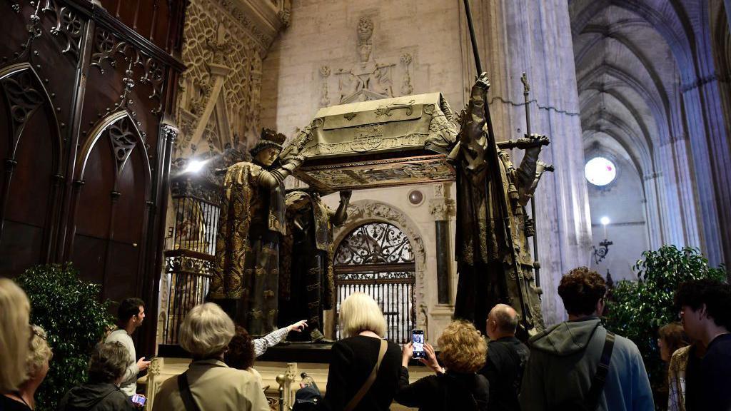 People visit the tomb of Christopher Columbus at the Cathedral of Seville on October 11, 2024