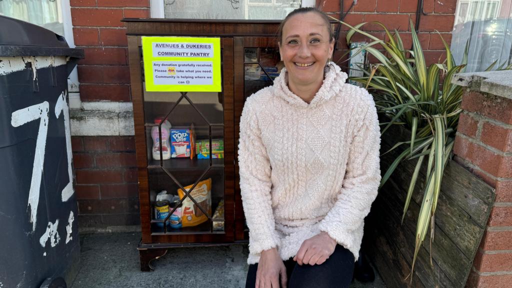 Woman creates community pantry at front of house