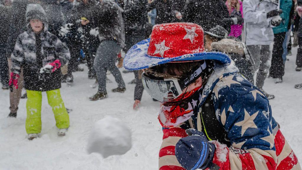 Man in US flag colours participating in the snowball fight in Washington DC's Meridian Hill Park 