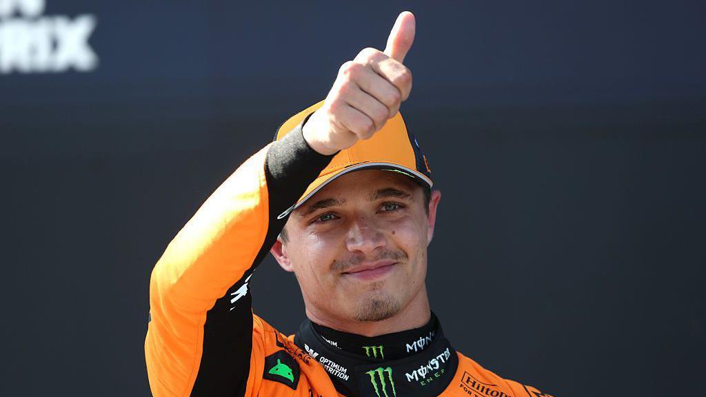 Lando Norris puts a thumbs up to the Austrian crowd 