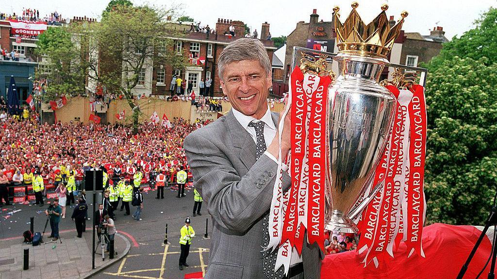 Arsenal boss Arsene Wenger celebrates with the Premier League title in 2004