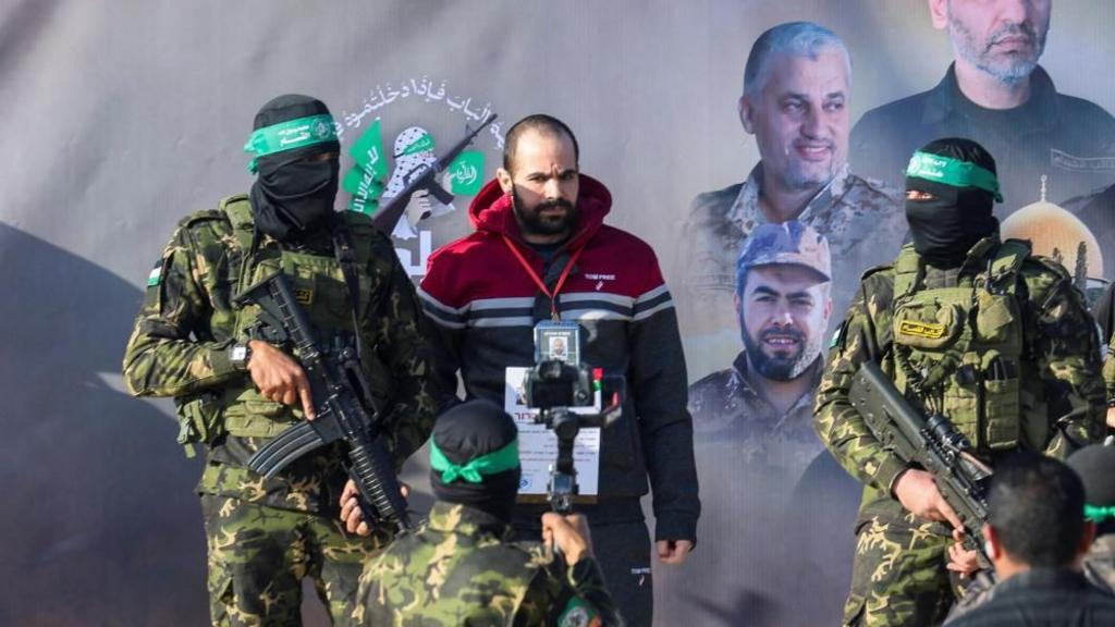 Yarden Bibas in centre, surrounded by military personnel with guns