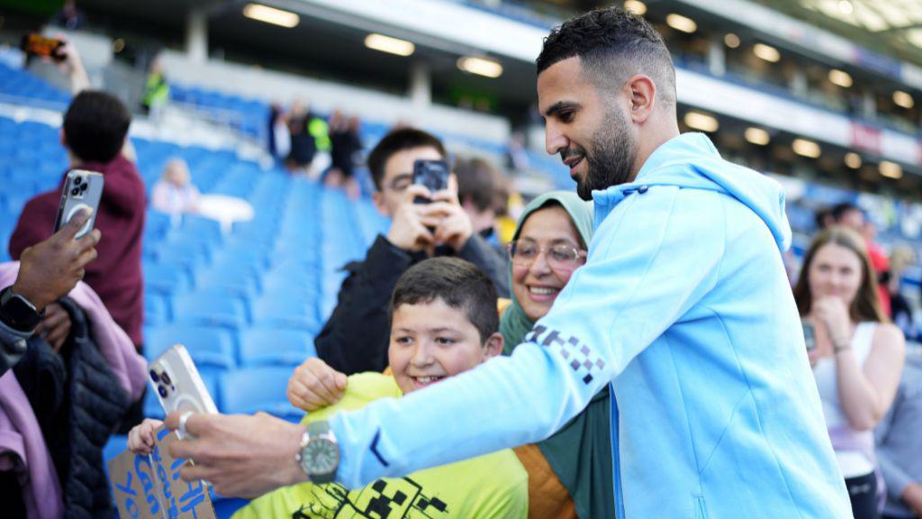 Riyad Mahrez taking selfie with supporter at the Amex Stadium