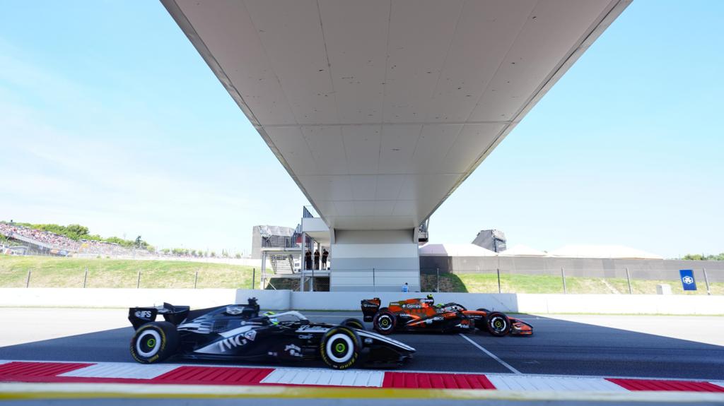McLaren's Lando Norris and Cadillac's Sergio Perez go under a bridge during final practice for the Barcelona-Catalunya Grand Prix