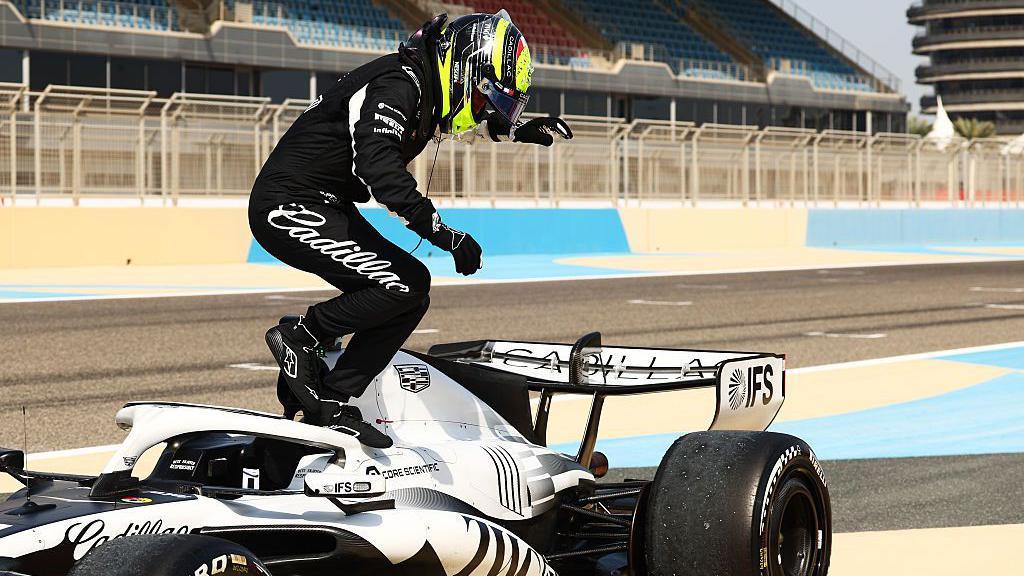 Sergio Perez jumps out of the Cadillac after stopping on track in testing