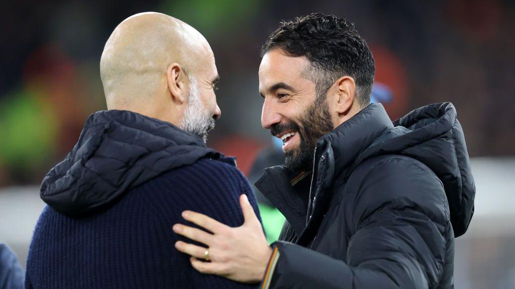 Pep Guardiola, Manager of Manchester City, and Ruben Amorim, Manager of Manchester United, interact prior to the Premier League match between Manchester City FC and Manchester United FC at Etihad Stadium