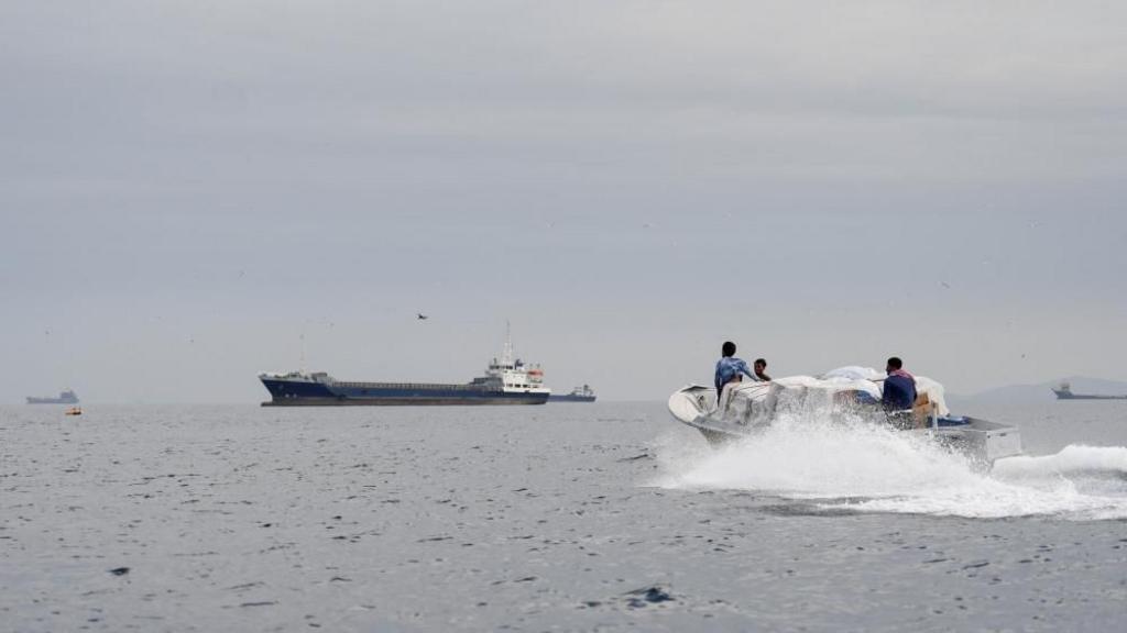 Vessels and a boat at the Strait of Hormuz, off the coast of Oman’s Musandam province