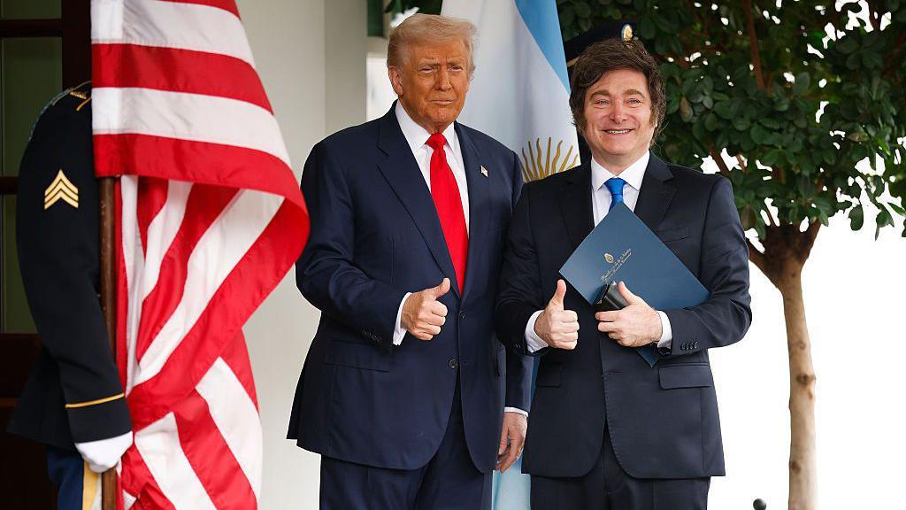 US President Donald Trump (L) and President of Argentina Javier Milei make the thumbs up sign standing at the White House on October 14, 2025