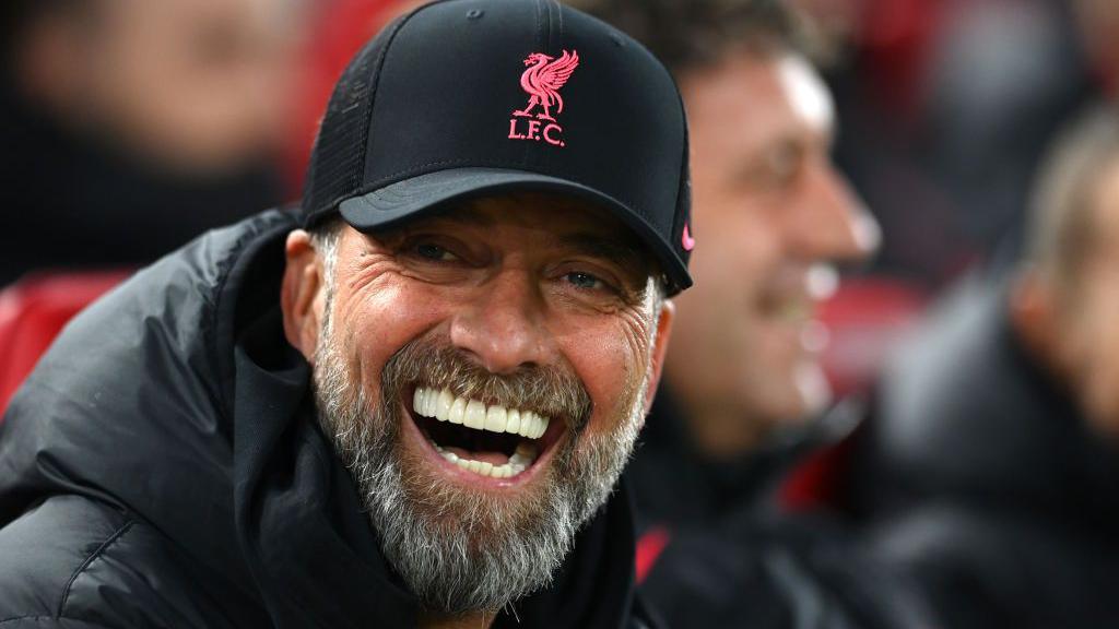 Jurgen Klopp smiling in a Liverpool hat