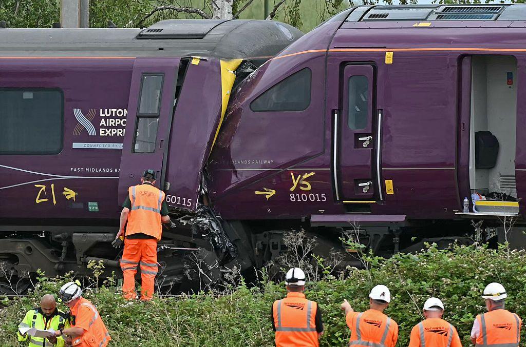 British Transport Police officers, Rail Accident Investigation Branch officers, and Network Rail work at the site of two East Midlands Railway (EMR) trains which crashed into each other.