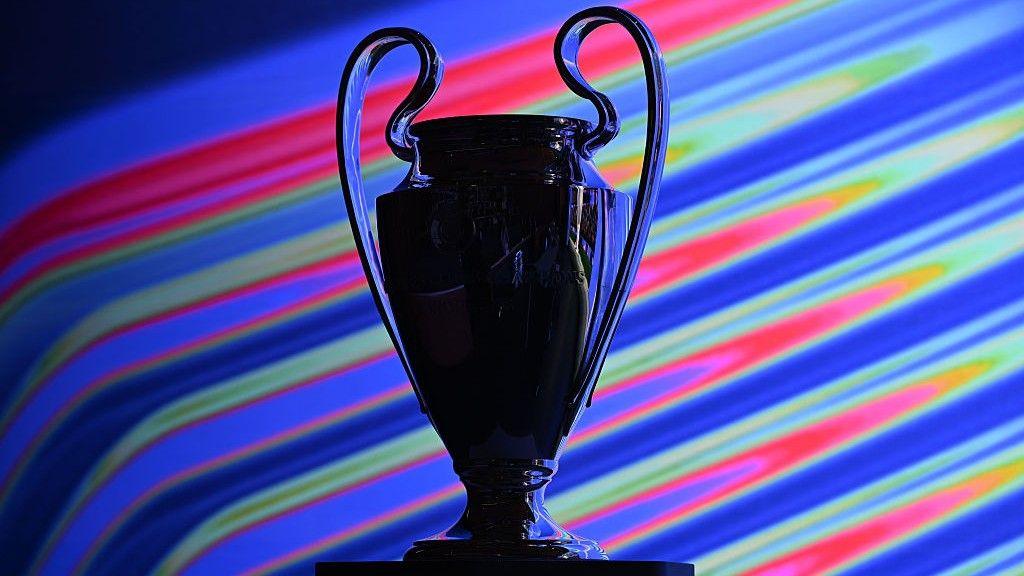 A silhouette of the Champions League trophy in front of a colourful background