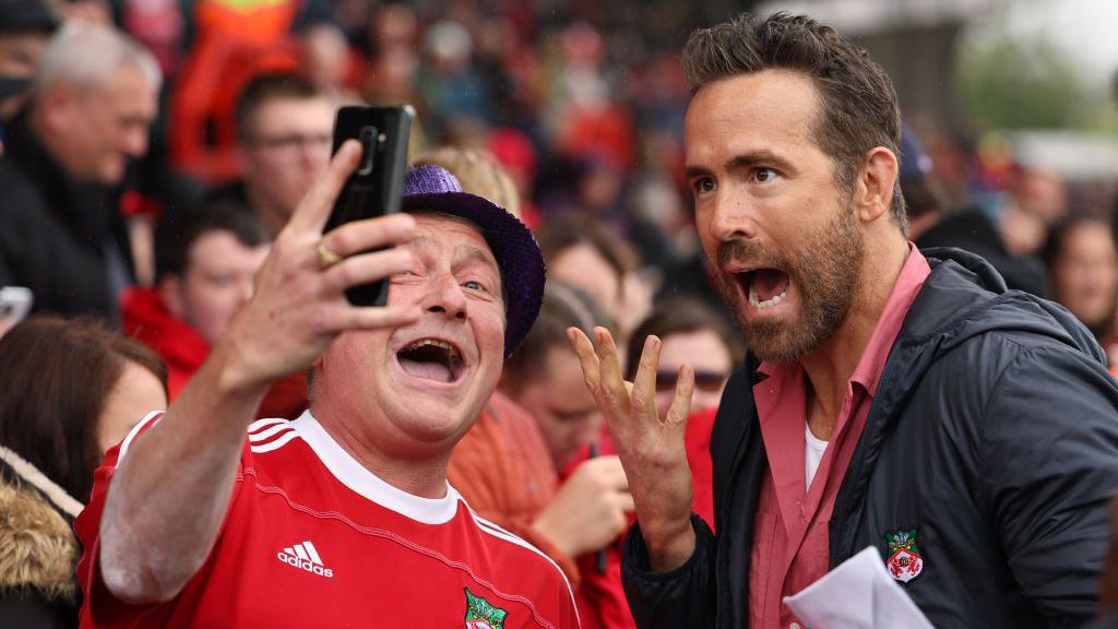 Ryan Reynolds poses for a selfie with a Wrexham fan